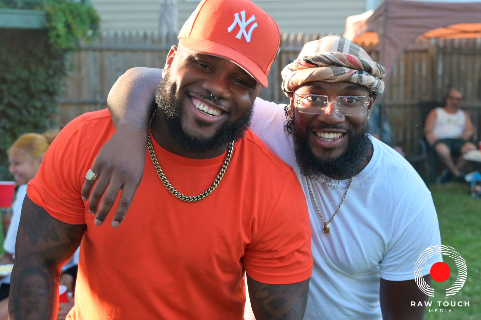 Two adults smiling together outdoors; original Raw Touch Media watermark preserved